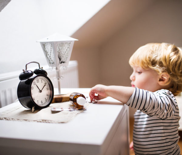 Toddler reaching for pill bottle